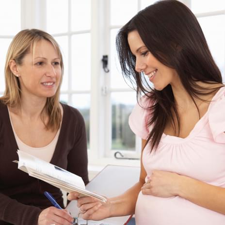 Midwife consulting pregnant woman